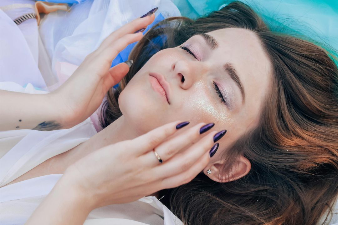 woman with both hands up to her face