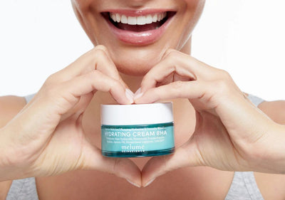 Smiling lady holding Melumé Skinscience Hydrating Serum 8HA