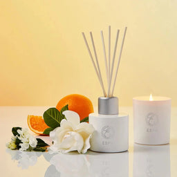 ESPA Positivity Reed Diffuser next to a lit candle