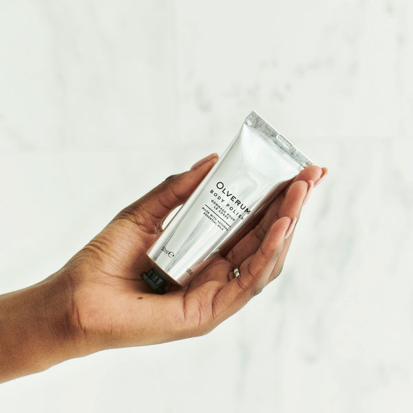 Olverum Body Polish held in the palm of a hand