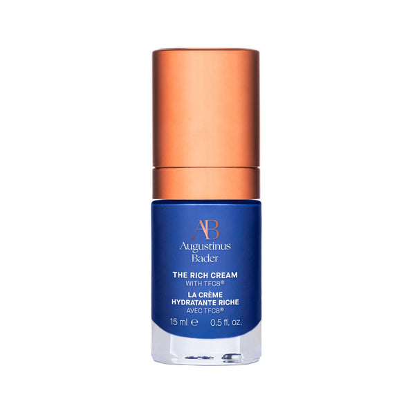 Blue skincare bottle with bronze cap on a white background