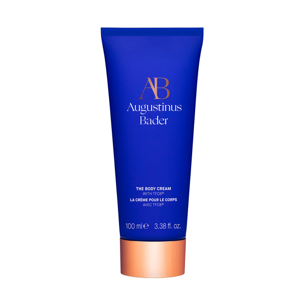 Blue tube of Augustinus Bader body cream on a white background