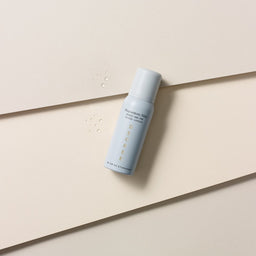 Decree Preparatory Mist with drops of texture next to the bottle