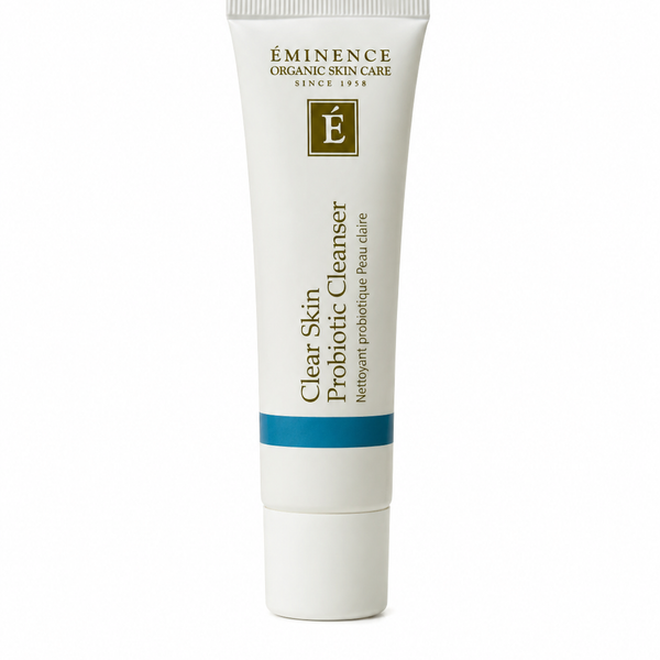 A white squeeze tube of Eminence Organic Skin Care Clear Skin Probiotic Cleanser with gold text and a blue accent band, centered on a white background.