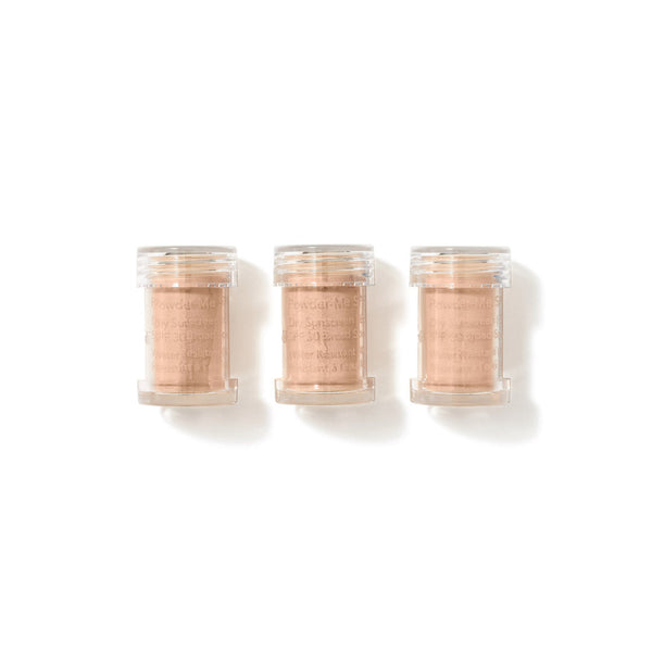 Three small clear plastic jars filled with a light peach-beige powder, arranged side by side on a white background.
