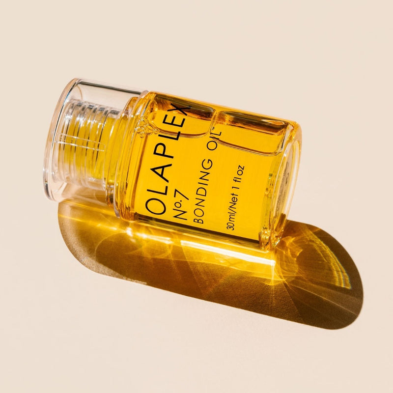 Olaplex No.7 Bonding Oil bottle  place horizontally with the sun lighting the oil