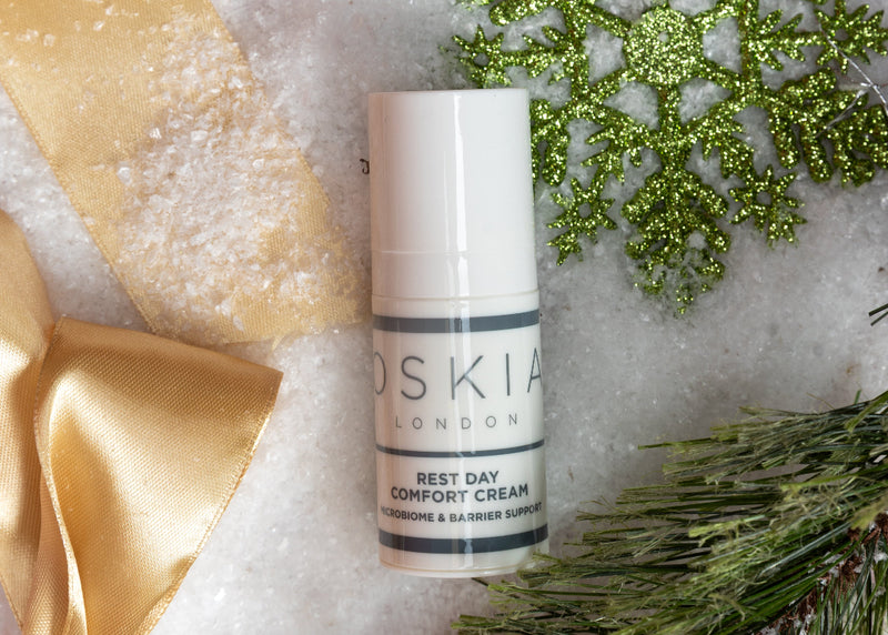 OSKIA Rest Day Comfort Cream bottle with decorative elements on a textured surface