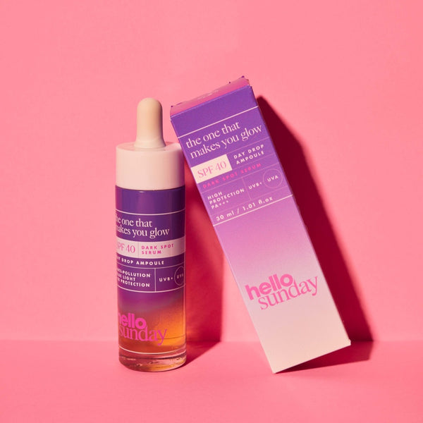 Hello Sunday The One That Makes You Glow Dark Spot Serum SPF40 and packaging on a pink surface