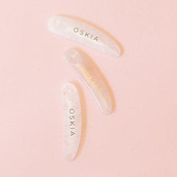 three OSKIA Quartz Spatulas on a pink surface