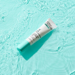 Clear skin spot gel on water on blue table