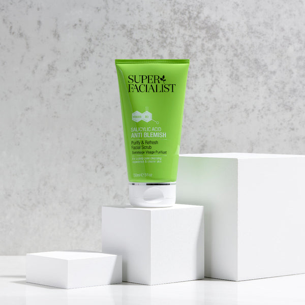 Salicylic acid facial scrub placed on top of a white cube