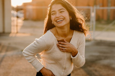 woman with brunette hair stood smiling 