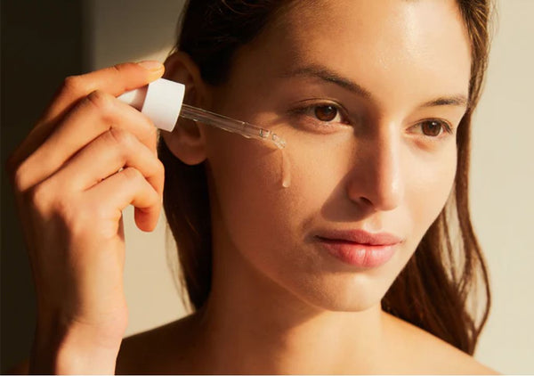 Lady applying Skin1004 serum to her face