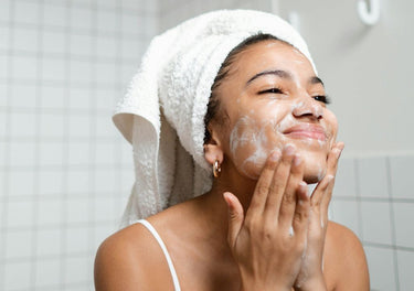 Lady washing her face in the mirror