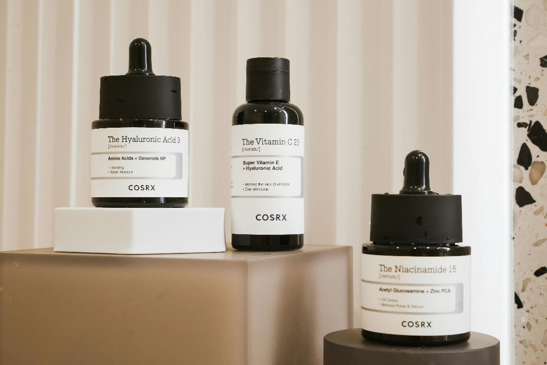 a trio of Cosrx products against a neutral background