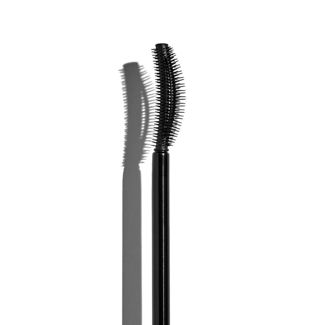 Black mascara wand on a white background