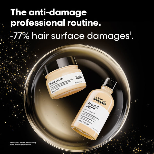 L'Or’ Paris Absolute Repair hair care set featuring a beige repair mask jar and a matching repair shampoo bottle, arranged inside a reflective gold bowl on a black background with gold sparkles and promotional text.