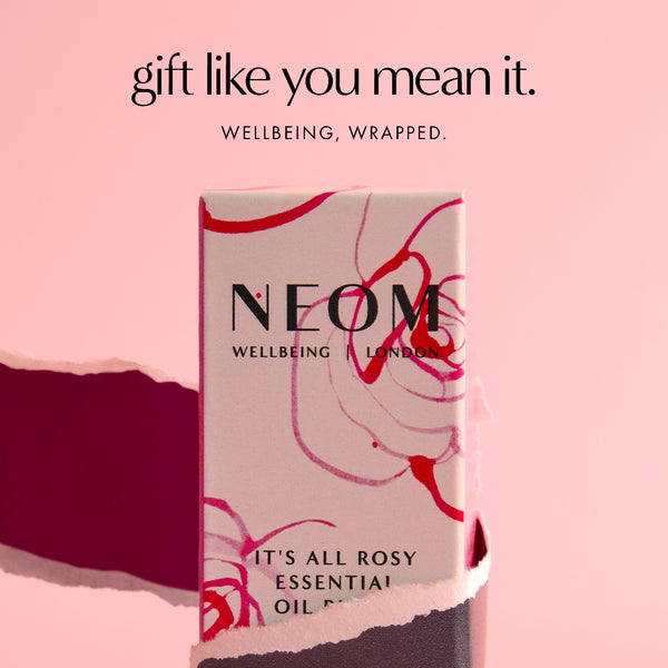 NEOM essential oil packaging on a pink background with text 'gift like you mean it.'