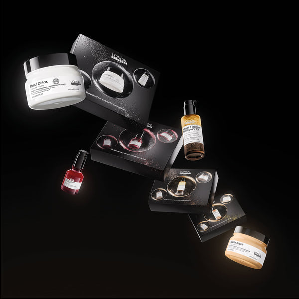 L'Or’ Paris nail care set arranged on a black background, including a white hair developer jar, a red nail polish bottle, a beige nail powder jar, and multiple black boxes with circular nail displays.