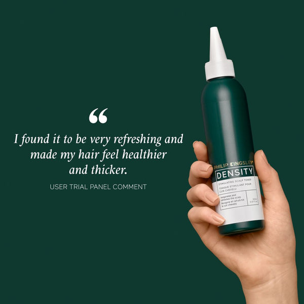 A hand holding a dark green bottle of L'Or’Paris Density Hair Building Fibers against a dark green background, with a user testimonial quote displayed on the left.