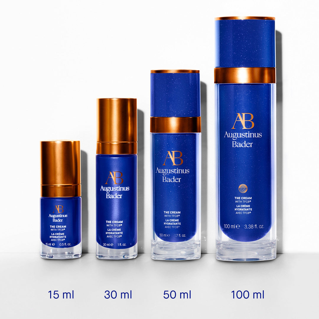 Set of Augustinus Bader skincare products with varying sizes on a white background