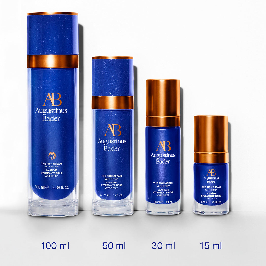 Set of Augustinus Bader skincare products in various sizes on a white background