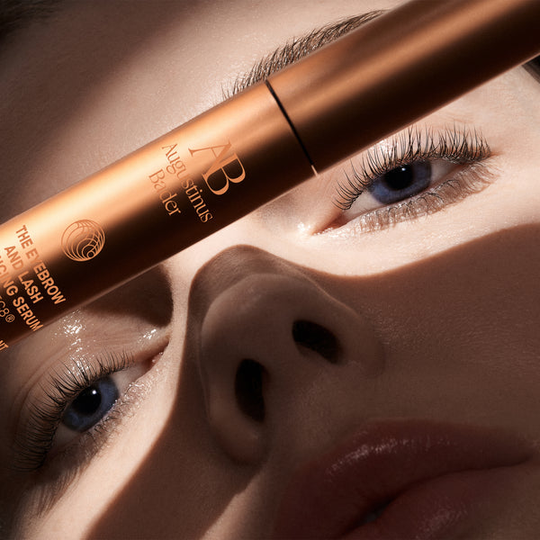 Close-up of a person's eye with a cosmetic product labeled 'AB' on the eyelid.