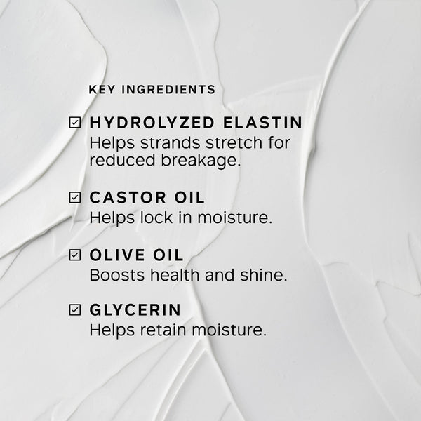 A close-up of a white cosmetic cream with visible texture and printed text listing key ingredients: hydrolyzed elastin, castor oil, olive oil, and glycerin.