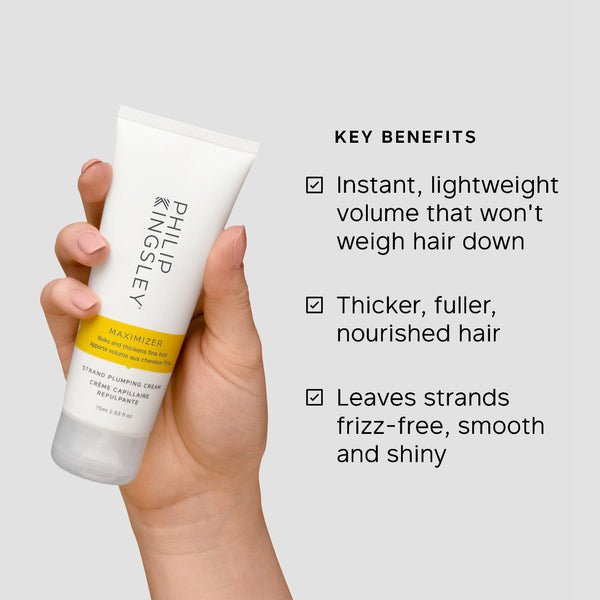 Hand holding a bottle of Phygley Maximizer with key benefits listed on a light gray background