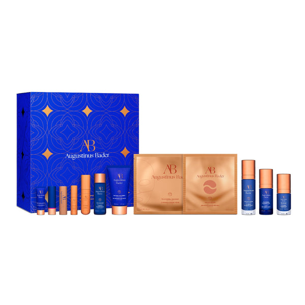 Augustinus Bader skincare product set with blue and gold packaging on a white background