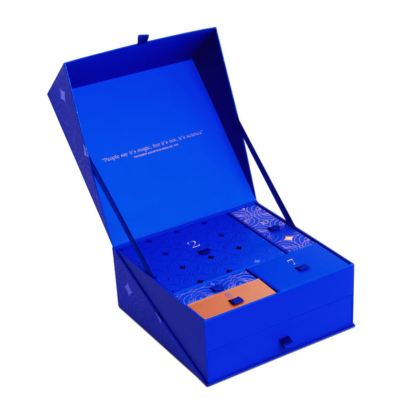 Blue gift box with a lid open, revealing items inside on a white background
