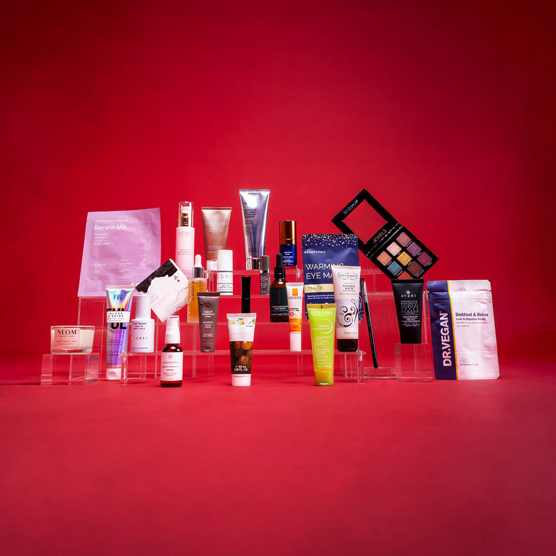 Collection of skincare and makeup products on a red background