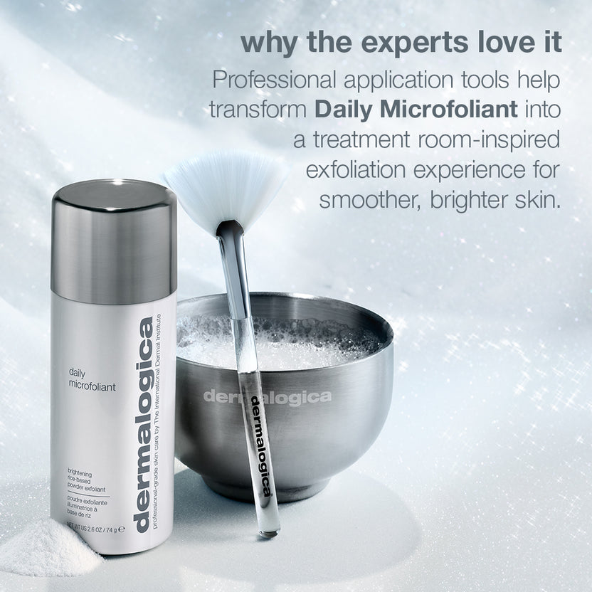 Dermalogica Daily Microfoliant skincare set featuring a white and silver spray bottle, a stainless steel bowl filled with exfoliating powder, and an applicator brush, set against a snowy white background with promotional text.