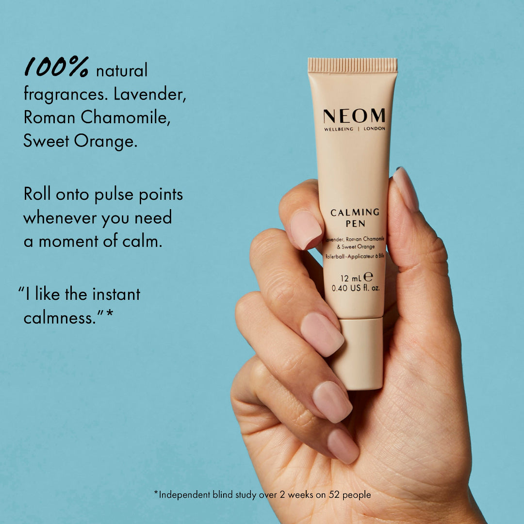 Neom calming pen held in a hand with product description on a blue background