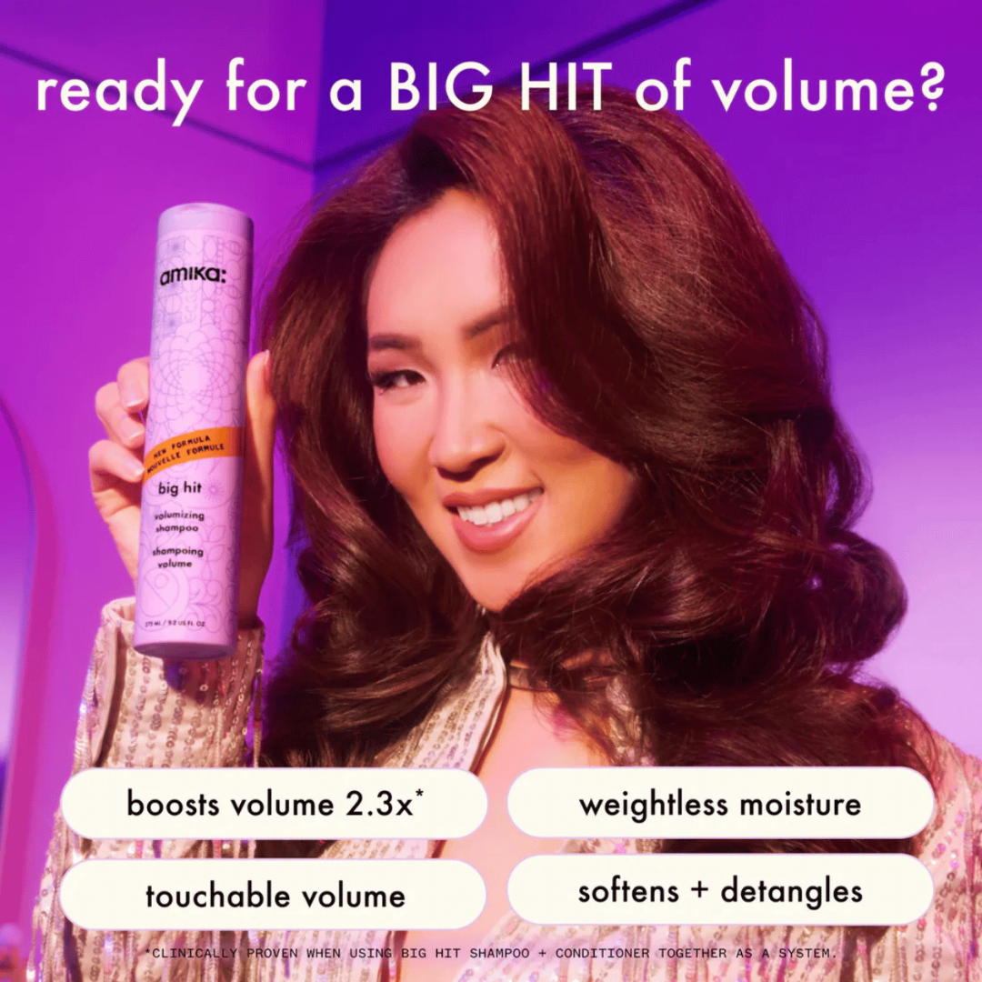 Woman holding a bottle of Omiika Big Hit shampoo with text about product benefits on a purple background