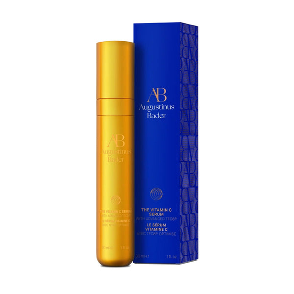 Gold serum bottle and blue box with 'AB Augustinus Bader' branding on a white background