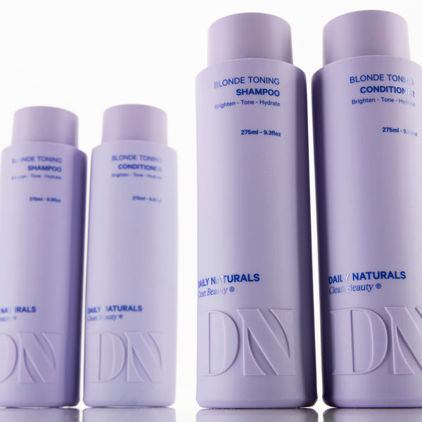 Set of Daily Naturals blonde toning shampoo and conditioner bottles on a white background