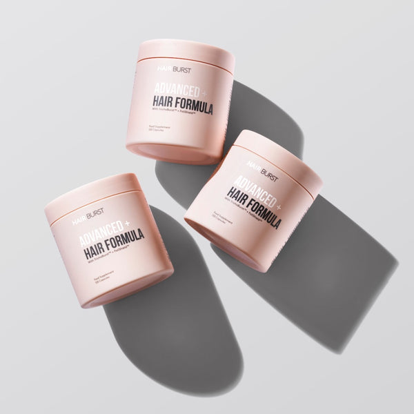 Three containers of BURST Advanced Hair Formula on a light gray background