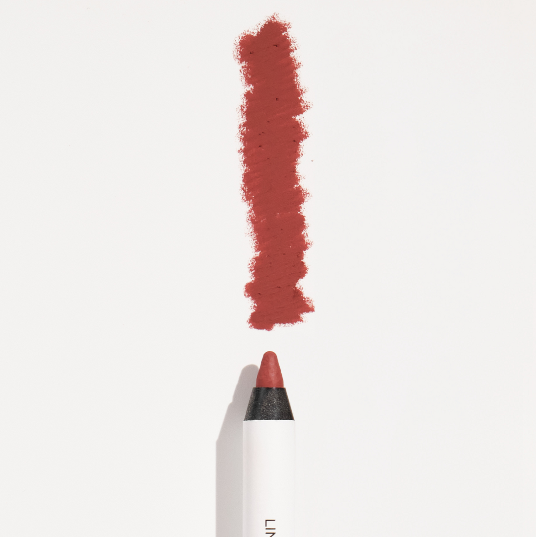 Lip liner pencil with red color swatch on a white background