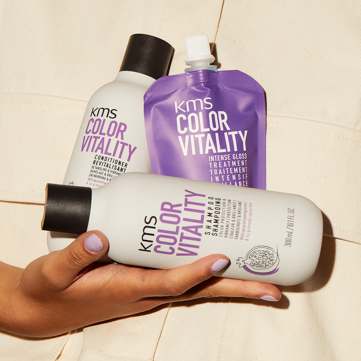 KMS Color Vitality shampoo, conditioner, and treatment on a beige background
