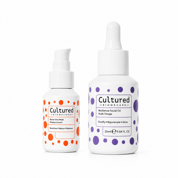 Two white skincare bottles from Cultured Biomecare on a white background: a smaller orange-dotted pump bottle labeled Berry One Mask, and a larger purple-dotted dropper bottle labeled Resilience Facial Oil.
