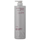 A tall, matte light gray pump bottle of Daily Naturals Everyday Balancing Shampoo on a plain white background.