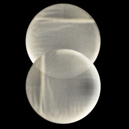 Two overlapping translucent circular lenses or discs on a solid black background.