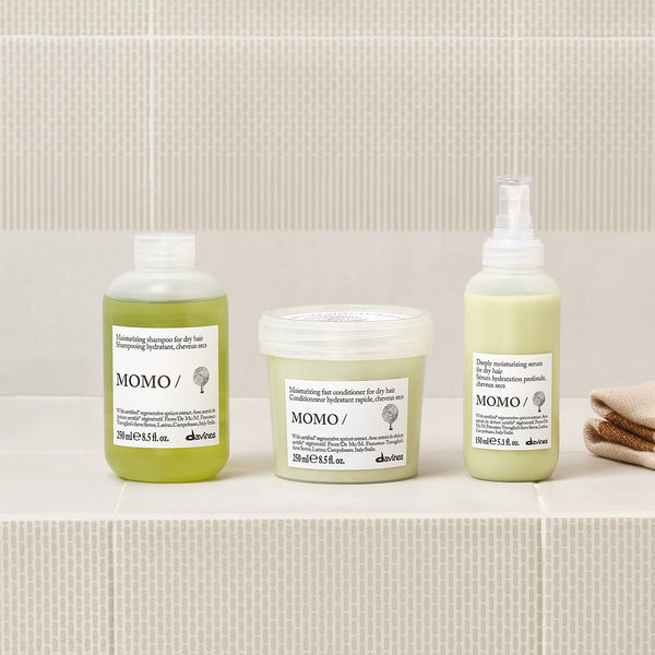 Three skincare products from the brand 'MOMO' on a neutral background