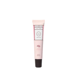 Pink lip balm tube with brand logo on a white background
