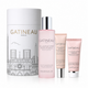 Gatineau Paris skincare set featuring a large white cylindrical box with black line art of Notre Dame de Paris, alongside a pink bottle of Collagen Expert Hydra Essence, a pink tube of Plump & Revive Eye Cream, and a pink tube of Smooth Cream, all on a white background.