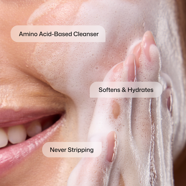 Close-up of a hand applying foam to a face with text indicating product benefits.