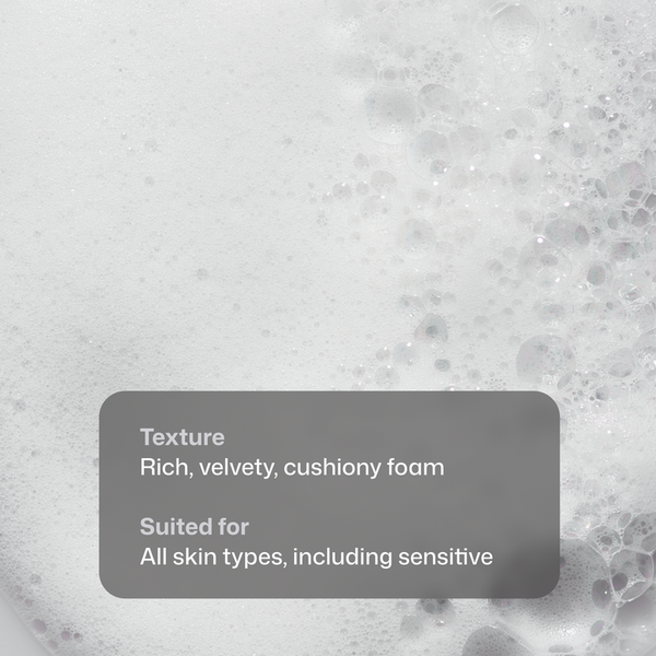 Close-up of a rich, velvety cushiony foam texture with bubbles and overlaid text reading 'Texture Rich, velvety, cushiony foam' and 'Suited for All skin types, including sensitive'.