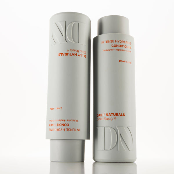 Two bottles of Daily Naturals hair care products on a white background