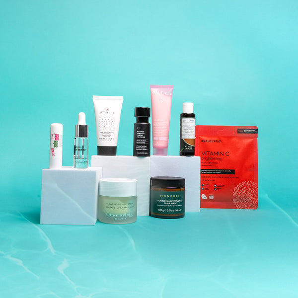 Collection of skincare products on a light blue background